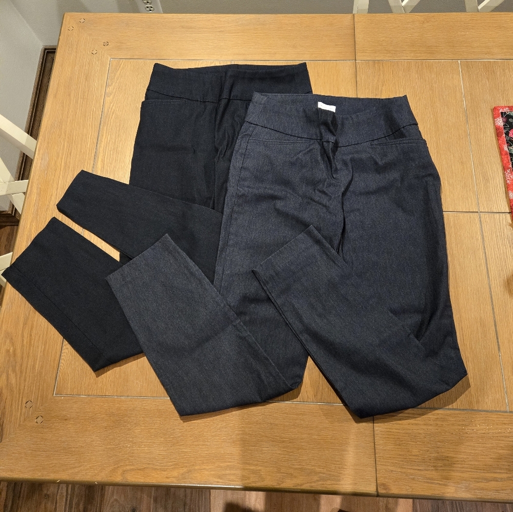 Two pairs of Van Heusen dress pants.